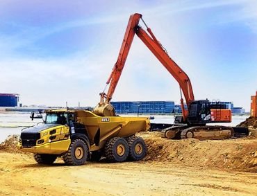 Tak Lee provides BELL articulated dump trucks (left) and HITACHI excavators (right)